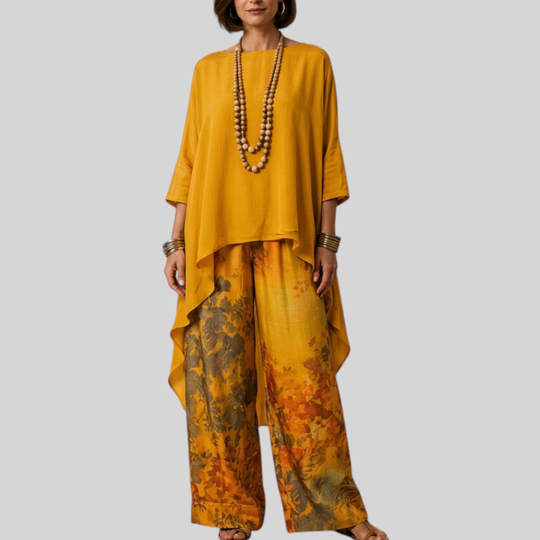 Vrouw draagt Wattle & Vale Melbourne Ivy elegante tweedelige set met okergele top en bloemrijke wijde broek