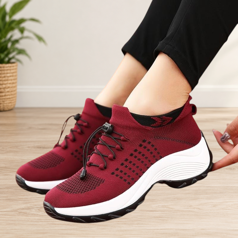 Wattle & Vale Melbourne FlexiFit slip-on sneakers in burgundy knit mesh with white soles on a running track.