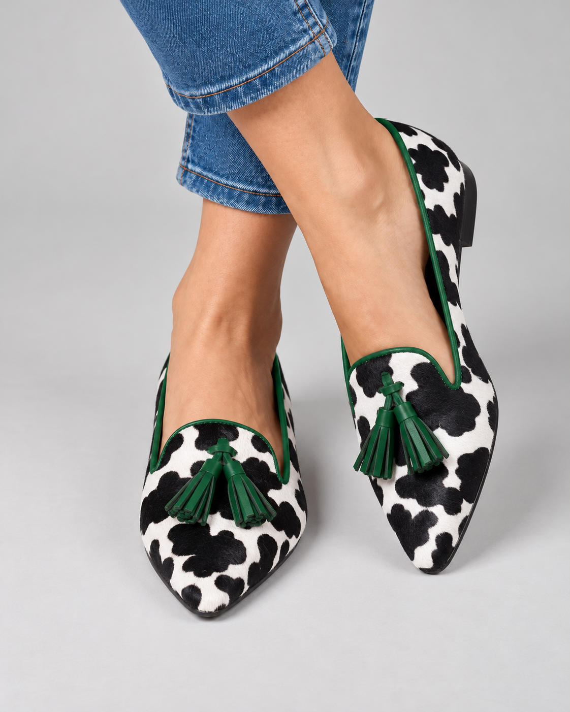 Ginevra Moccasin — Black and White Cow Print, Green Tassels