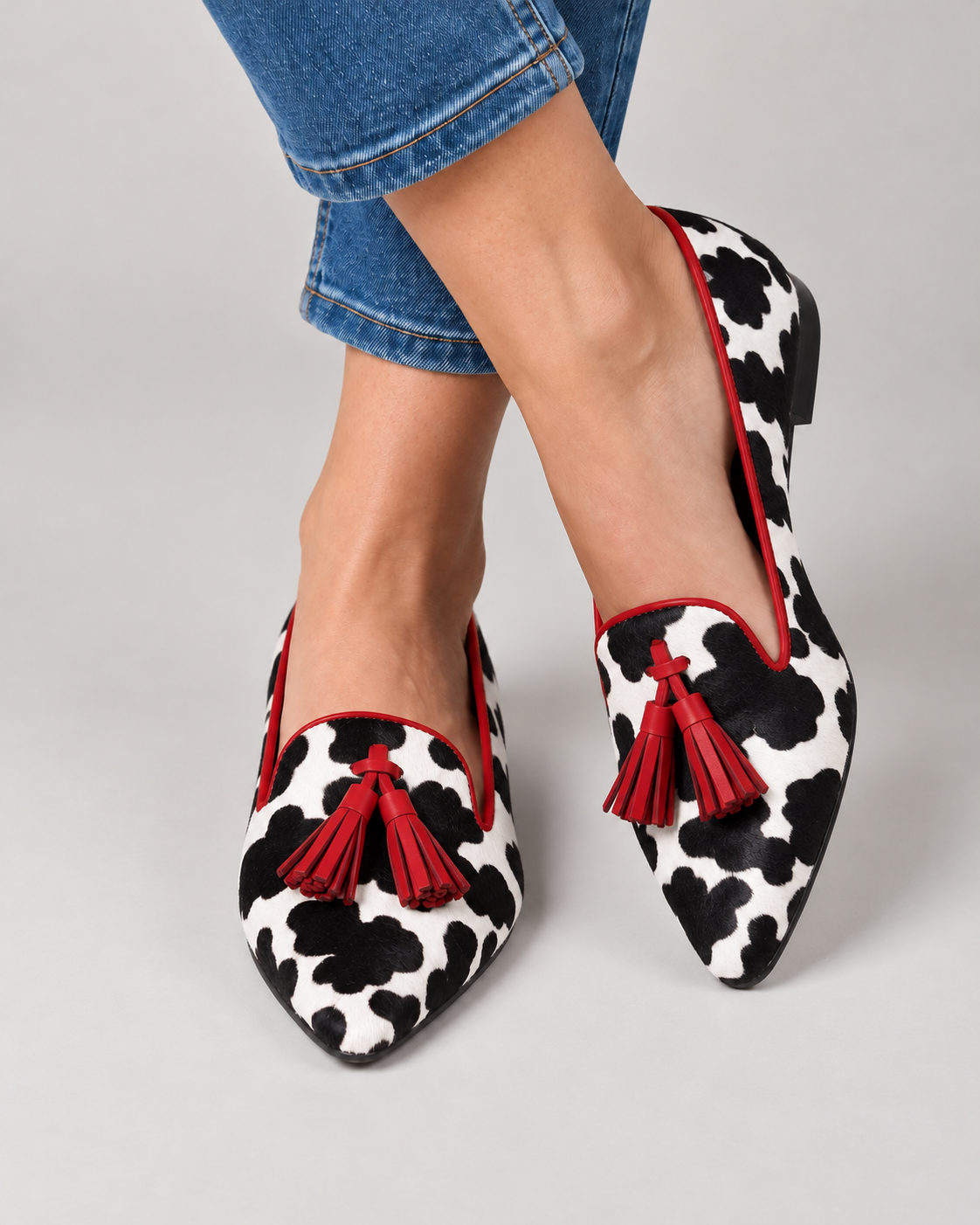Ginevra Moccasin — Black and White Cow Print, Red Tassels
