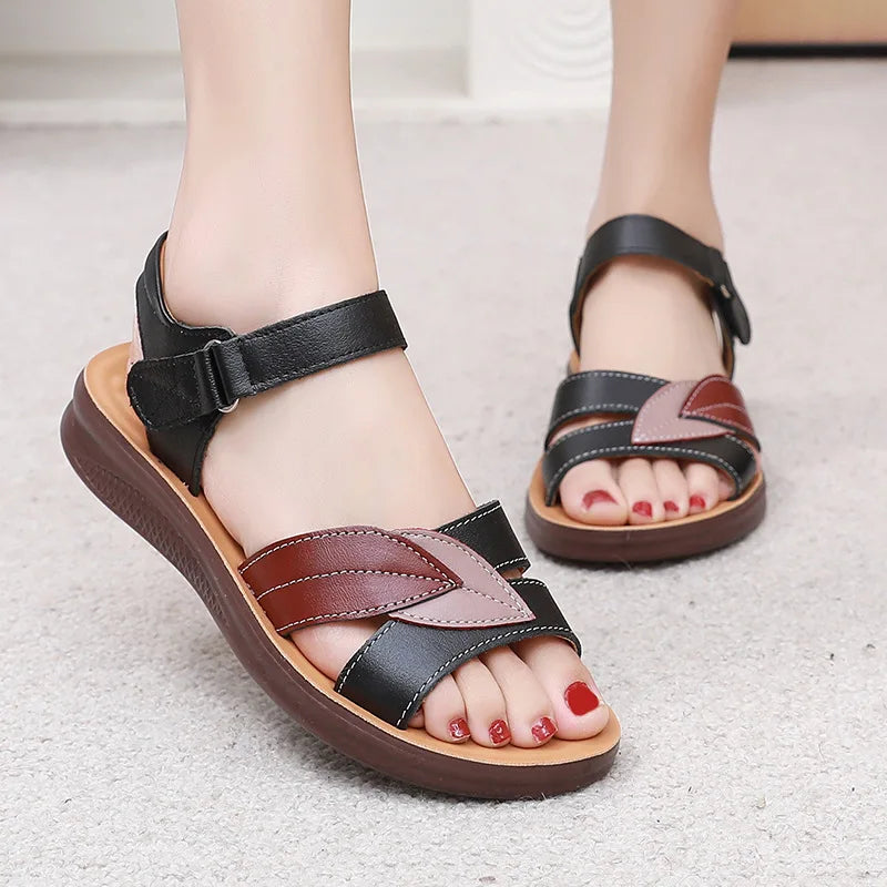 Woman wearing the Ivy sandals in black and burgundy